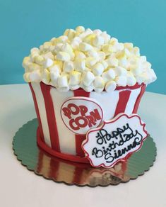 a birthday cake made to look like a popcorn bucket with marshmallows in it