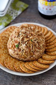 a white plate topped with crackers and a cheese ball