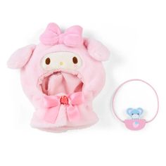 a pink hello kitty hat and headband with a teddy bear on the front, sitting next to it