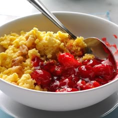 a white bowl filled with cranberry sauce and bread