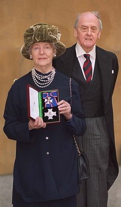 an older man and woman standing next to each other