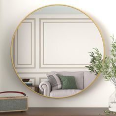 a living room with a couch and a round mirror