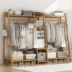 an open closet with clothes and baskets on the floor, next to a white rug