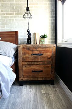 a bedroom with a brick wall and wooden furniture