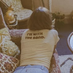 a woman sitting on top of a couch next to a table