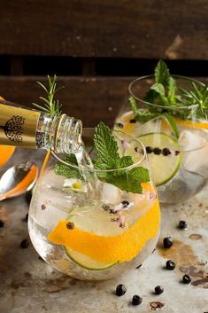 two glasses filled with lemonade and mint garnish