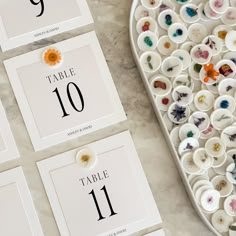 the table numbers are decorated with buttons and flowers