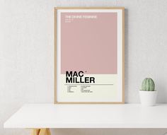 a poster with the name mac miller on it next to a potted cacti