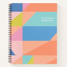 a spiral notebook with the name juliana anderson on it in blue, pink, yellow and orange