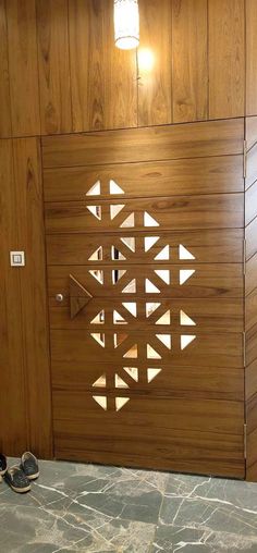 a wooden door with laser cut designs on it