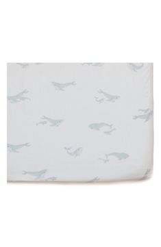 a white sheet with blue whale print on it