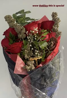 a bouquet of flowers wrapped in plastic wrap