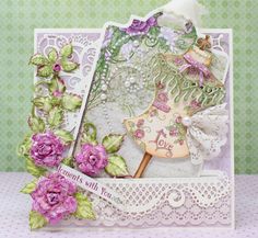 a card with flowers and lace on it