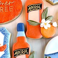 decorated cookies with orange and blue designs on them, including an apricot bottle