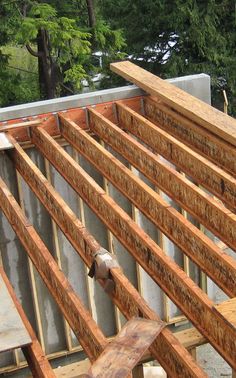 an unfinished house being built with wood framing and metal studs on the roof top