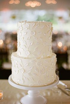 a white wedding cake sitting on top of a table