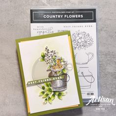 a card with some flowers on it sitting next to a paper crafting kit that says country flowers