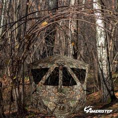 a camouflaged hunting blind in the woods