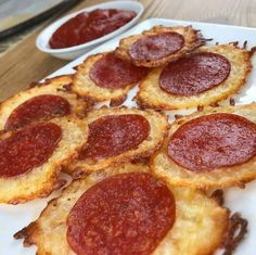 small slices of pepperoni pizza on a plate with dipping sauces in the background