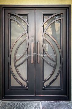 an iron door with glass panels on the front and side doors, which are designed to look