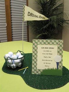 a golf themed table with a basket of balls and a driving name sign on it