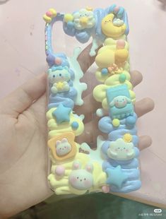 a person holding up a phone case with animals and bears on it's sides