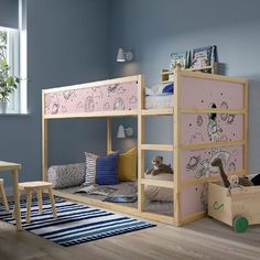 a child's bedroom with bunk beds and toys on the floor in front of it