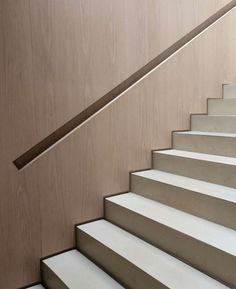 a close up of a set of stairs with wood paneling on the wall behind it