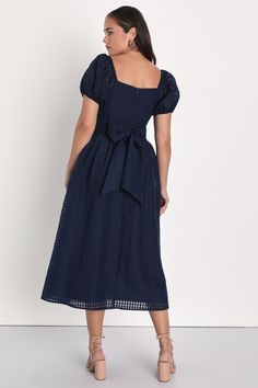 Your darling personality will be irresistible in the Lulus Certain Charisma Navy Blue Textured Puff Sleeve Midi Dress! Sturdy woven fabric, with a burnout checkered texture, shapes short puff sleeves with elastic at the cuffs and shoulders. Square neckline tops a darted bodice with a high waist and a wide sash tie. Pleated details lend a voluminous silhouette to the A-line skirt, ending at a midi hem. Hidden zipper/clasp at back. Fit: This garment fits true to size. Length: Mid-calf length. Size Dresses With Bow, Puff Sleeve Midi Dress, Midi Dress Formal, Evening Dresses Cocktail, Textured Dress, Mini Skater Dress, Wedding Guest Dresses, Sleeve Midi Dress, Glam Dresses