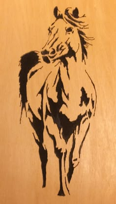 a drawing of a horse on a wooden surface