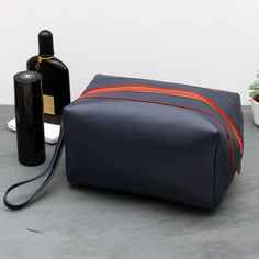 *This personalised navy luxury wash bag is a stylish accessory that makes the perfect gift for any man. The embossed navy toiletry bag is adorned with a vibrant orange zipper detail, adding a modern touch to its classic design.  *Crafted from genuine leather, this spacious men's wash bag is ideal for a man on the move. Featuring ample space for toiletries and cosmetics, this initial wash bag caters to the needs of those with active lifestyles.  *Adding a personal touch by embossing the recipient's initials makes it an even more special gift. *Whether it's for Father's Day or to celebrate that special man in your life, this wash bag offers a touch of luxury that perfectly complements his on-the-go lifestyle. PERSONALISATION  * We emboss our pieces to create bespoke items especially for you, Personalised Baby Bracelet, Mens Bracelet Personalized, Leather Wash Bag, Leather Watch Box, Engraved Handwriting, Girls Personalized Gifts, Boys Jewelry, Bespoke Gifts