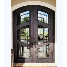 the front door to a house with two double doors and glass panels on each side