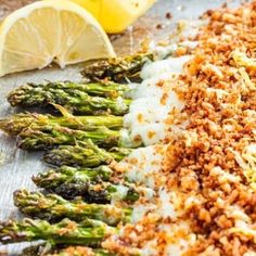 asparagus with lemons and parmesan cheese on the side