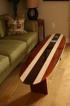 a surfboard shaped coffee table sitting in front of a couch