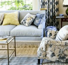 a living room filled with furniture and pillows