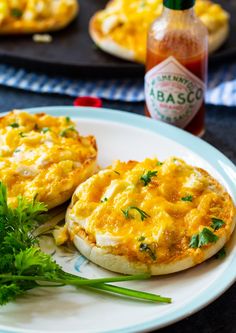 two eggs are sitting on a plate next to some ketchup and parsley