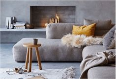 a living room filled with furniture and a fire place in the middle of the room