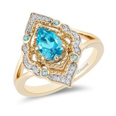 a gold ring with an oval blue topazte surrounded by small white and yellow diamonds