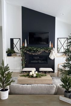 the living room is decorated for christmas with greenery and candles on the coffee table