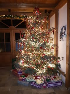 a decorated christmas tree with presents under it