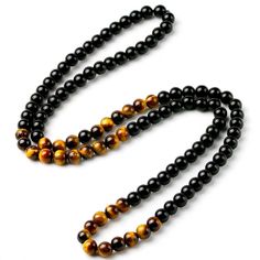 Not only does the Natural Black Onyx and Tiger Eye Stone Beaded Necklace look great and make the perfect gift for someone. The Tiger Eye represents the power, courage and fearlessness of the tiger. Tigers Eye is a must have if you are looking for balance and harmony in your life and will improve your sense of self-worth. You will feel empowered and confident and it can strengthen your willpower and your intention to succeed. It’s considered to be a protector of the wearer’s resources, bringing p Stone Bead Necklace, Wholesale Necklaces, Tigers Eye Necklace, Mens Jewelry Necklace, Stone Beaded Necklace, Unisex Necklace, Natural Stone Jewelry, Mala Necklace, Tiger Eye Stone