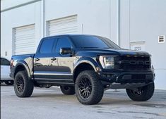 a black truck parked in front of a building