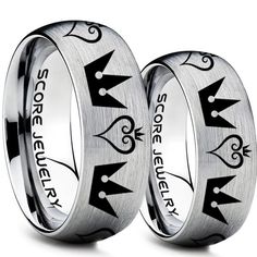 two wedding rings with arrows and the words sorcement on each one, both engraved in