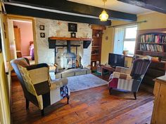 a living room filled with furniture and a fire place