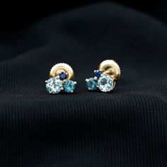 Product Details These Three Stone Stud Earrings embellished with Round Shape Sky Blue Topaz, London Blue Topaz and Blue Sapphire Gemstones are set in a Prong Setting. Product Information SKU SHP-EARRINGS102025073 Length 6 mm Width 7.2 mm Height 3.2 mm Weight 0.88 gm (Approximate) BLUE SAPPHIRE INFORMATION No.of Stones 2 Pieces Total Weight 0.10 Carat (Approximate) Dimension(approx) Round-2X2 mm-2 Pcs Color Blue Cut Brilliant Shape Round Setting Type Prong-Setting Quality Grade AAA LONDON BLUE TO Formal Blue Birthstone Earrings, Blue Birthstone Earrings For Formal Occasions, Blue Topaz Birthstone Earrings, Blue Topaz Birthstone Round Earrings, Sapphire Blue Topaz Round Earrings, Anniversary Blue Topaz Multi-stone Earrings, Fine Jewelry Blue Topaz Earrings With Gemstone Accents, Anniversary Multi-stone Blue Topaz Earrings, Fine Jewelry Topaz Birthstone Earrings