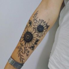 a woman's arm with a sunflower tattoo on the left side of her arm