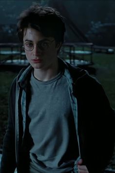 harry potter in glasses looking at the camera with his hand on his hip and one eye open