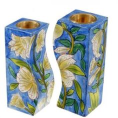 two blue vases with flowers painted on them