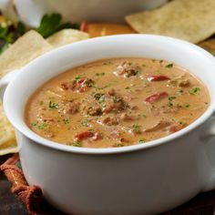 a white bowl filled with soup next to tortilla chips