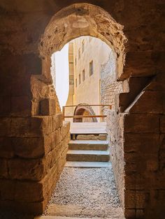 an alley way with stone steps leading up to the building